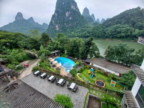 an aerial view of a resort with mountains in the background at Yangshuo Li River Resort in Yangshuo
