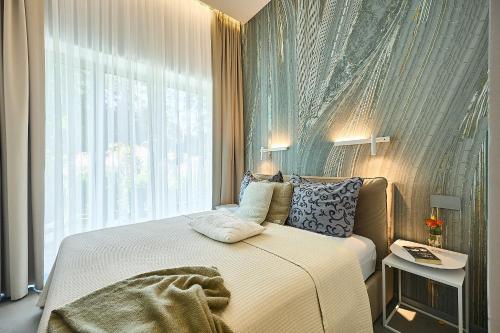 a bedroom with a bed with a large window at Solmare Luxury Apartment in Świnoujście