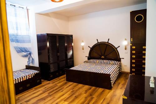 a bedroom with a bed and a wooden floor at Sottocoperta Palinuro in Palinuro