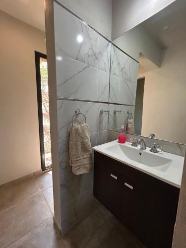 a bathroom with a sink and a mirror at Refugio de las nubes in Las Rabonas