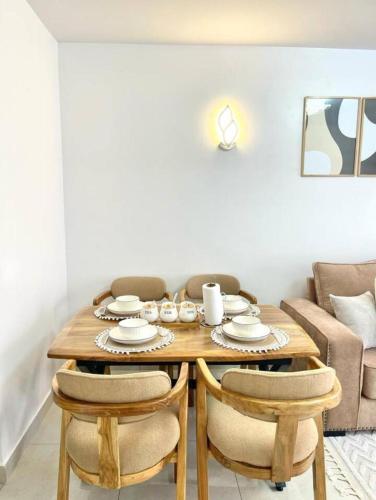 a dining room with a wooden table and chairs at Serene Homes in Nairobi