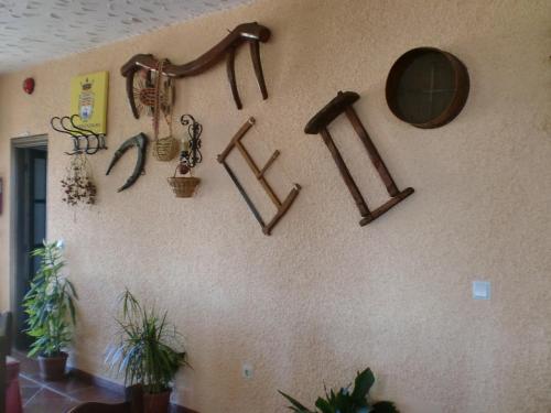 a wall with a bunch of wooden items on it at Hotel Restaurante Atalaya in Comares