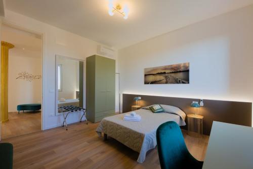 a bedroom with a bed and a couch in a room at Camera Denver - La Casa di Carta Affittacamere in Udine