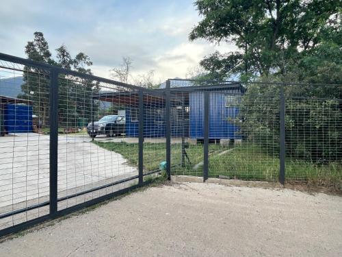 a fence with a fire hydrant in a parking lot at Depto Independiente Mostazal in La Punta