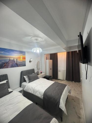 a hotel room with two beds and a flat screen tv at Grand Süleymaniye Hotel in Istanbul