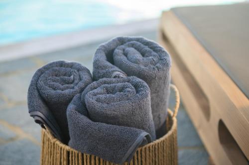 a bunch of towels are in a basket at Sunny Villa Sifnos in Apollonia