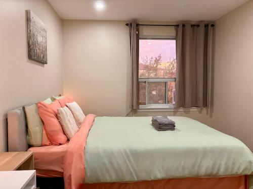 a bedroom with a bed and a window at Vita House near Downsview and Yorkdale Shopping Center in Toronto