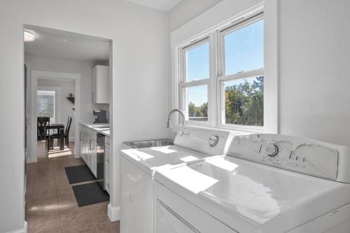 a white kitchen with a sink and a window at Spacious 4 Bed Home - In-Law Unit -Near SF and Napa in Vallejo