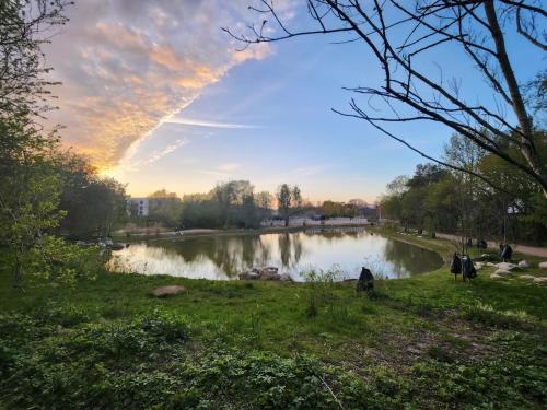a view of a river with a rainbow in the sky at Nice home with free parking close to downtown and nature! in Copenhagen