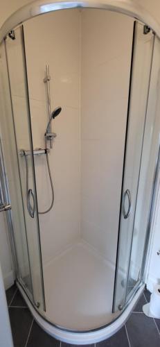 a shower with a glass door in a bathroom at The Willows in Stockton-on-Tees