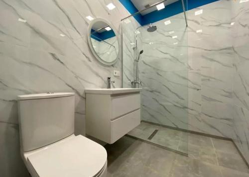 a bathroom with a toilet and a sink and a mirror at ''Malibu'' Apartment with 2 Bedrooms and Open Balcony, Yerevan CITY CENTER-Buzand Street in Yerevan