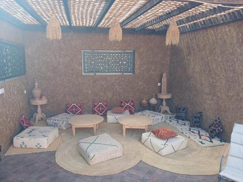 a room with couches and tables in a room at Maison almassira in Agadir