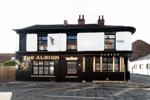 an old black building with the albury sign on it at The Albion Hotel in Hull