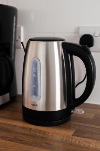 a black and silver tea kettle on a table at The Albion Hotel in Hull
