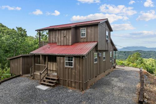 a large wooden building with a red roof at John Wayne View cabin in Del Rio