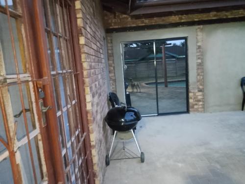 a black chair sitting on a patio next to a door at Blissful Breeze in Richards Bay