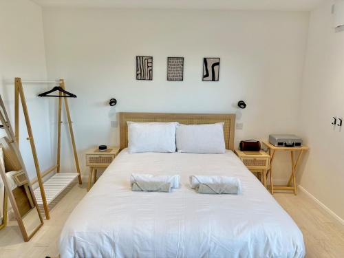 a bedroom with a large white bed with two pillows at Eco-Friendly Highland Suite with Mountain Views in Spean Bridge