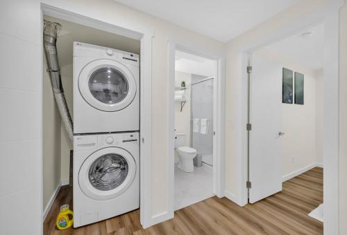 a white laundry room with a washer and dryer at Brand New Private Secondary Suite in Mahogany in Calgary