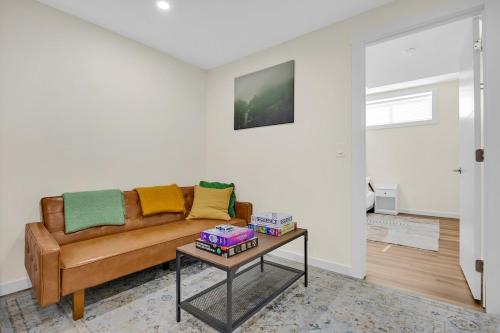 a living room with a couch and a table at Brand New Private Secondary Suite in Mahogany in Calgary
