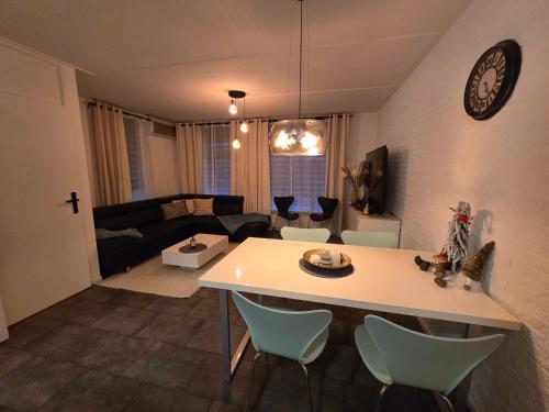 a kitchen and living room with a table and chairs at Stay Rijn Tolkamer in Tolkamer