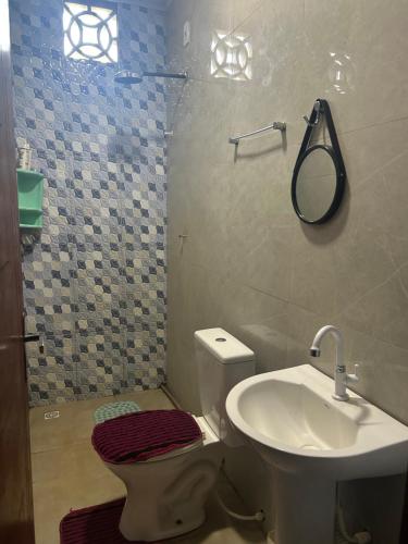 Un baño con lavabo, inodoro y espejo. en Quarto privativo,não é compartilhado!, en Parauapebas