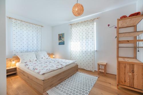 a small bedroom with a bed and a ladder at Sweethome Apple in Fiumes