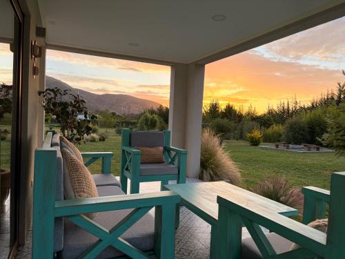 a patio with two chairs and a table on a porch at Casa Lolol Colchagua in Rincón de Ubilla