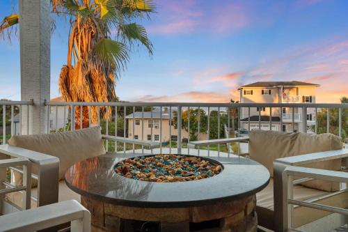 a pizza sitting on top of a table on a balcony at Aqua Vista l Beach Views I Pool Spa in Butler Beach
