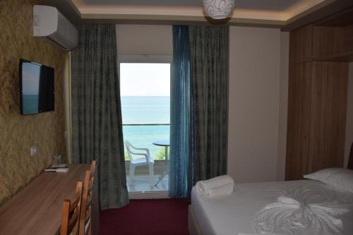 a hotel room with a window with a view of the ocean at Hotel Pogradeci 2 in Pogradec