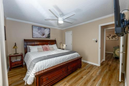 a bedroom with a bed and a ceiling fan at 3-Bedroom Home with King Bed, Smart TVs & Fenced Yard in New Bern