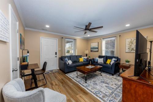 a living room with a couch and a table at 3-Bedroom Home with King Bed, Smart TVs & Fenced Yard in New Bern