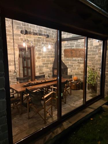 a view of a patio with a table and a fireplace at Cozy Nest House Δίκορφο Ζαγορίου in Dikorfo