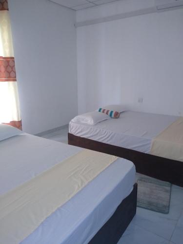 two beds in a room with at Sadew Villa in Anuradhapura