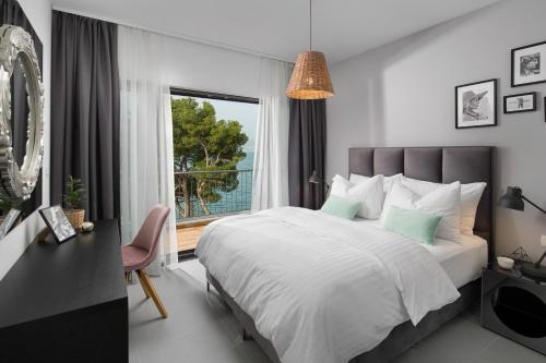 a bedroom with a large bed and a window at Olive Hill House - first floor in Slatine