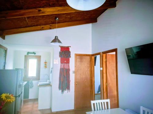 a room with white walls and a wooden ceiling at Cabañas Ruben Dario 1 in Puerto Natales