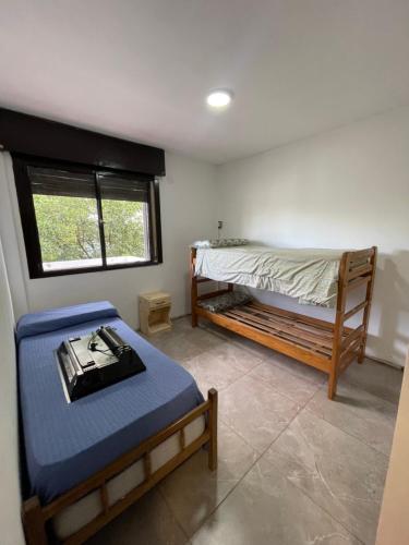 a bedroom with two bunk beds and a window at Marlu house in San Nicolás de los Arroyos