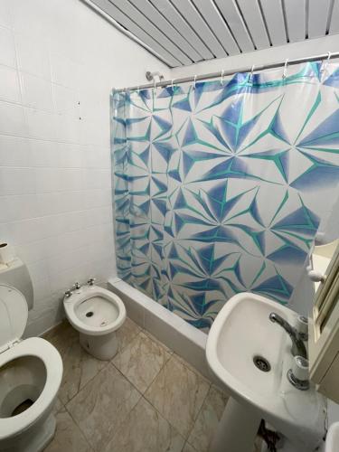 a bathroom with a toilet and a sink and a shower at Marlu house in San Nicolás de los Arroyos
