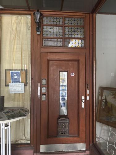 a wooden door with a pay phone on it at Geni Apartments in Traben-Trarbach