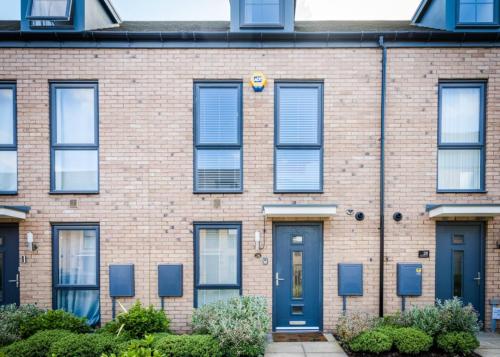 a brick building with blue doors and windows at Trade Stays Welcome Secure Parking Large Townhouse Long Stay Savings Available just Ask! in Birmingham
