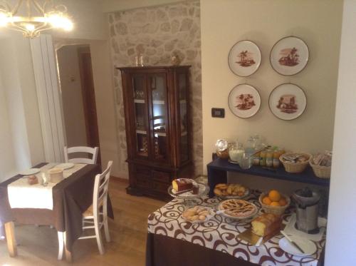 a dining room with a table with food on it at B&B Villa Delle Rose in Roccaraso