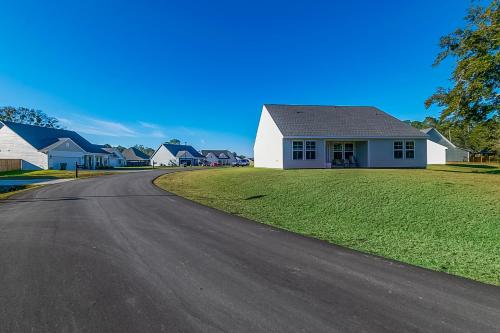 a house on the side of a road at BRAND NEW, fully furnished 3 bedroom, 3 bathroom home in Ocean Springs! in Gulf Hills