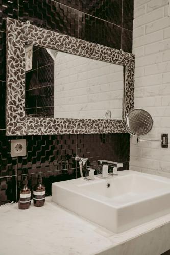 a bathroom with a white sink and a mirror at Puri Dewa Partha in Ungasan