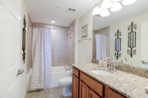 a bathroom with a sink and a toilet at Beachview Condo at Legacy Tower 2 -206 - fully furnished 2 bedroom 2 bathroom in De Buys