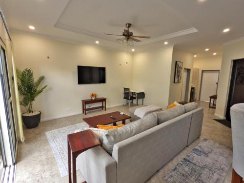 a living room with a couch and a table at The Emerald Apartments Ibex Meanwood in Lusaka