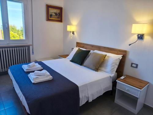 a bedroom with a large bed with towels on it at Casa delle zie Savoretti in San Clemente