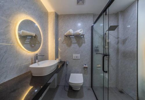 a bathroom with a sink and a toilet and a shower at Kirulhiya Omadhoo - Live the Island Dream in Omadhoo