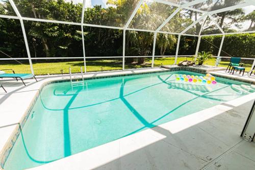 a large swimming pool with a pool noodle game at Oleander Drive - Coquina Sands in Naples