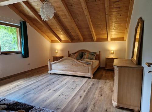 a bedroom with a bed and a wooden ceiling at Waldbach-Oase in Thurmansbang
