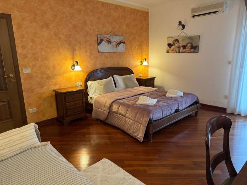 a bedroom with a bed and two nightstands and a bed sidx sidx sidx at Chiarelli House in Udine