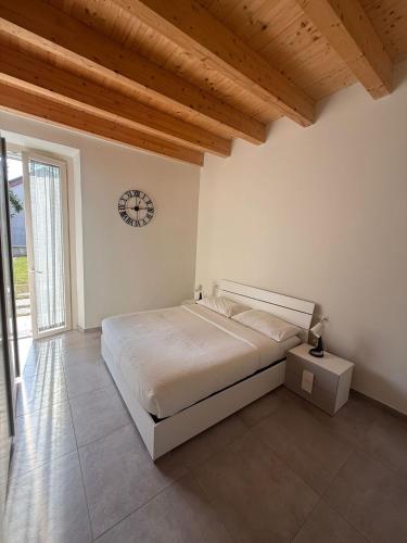 a bedroom with a bed and a clock on the wall at Riverwell in Sesto Calende